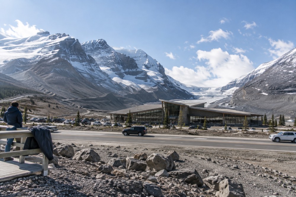 The Columbia Icefield Discovery Centre with the Athabasca Glacier visible across the highway