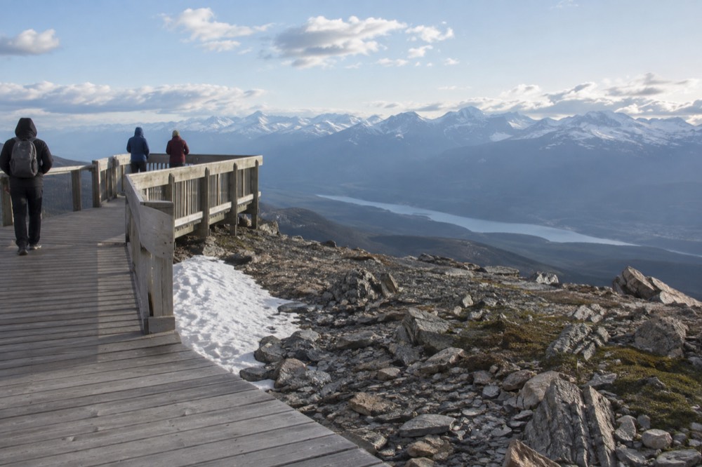 Boardwalk and viewing platforms at a mountain summit above alpine terrain