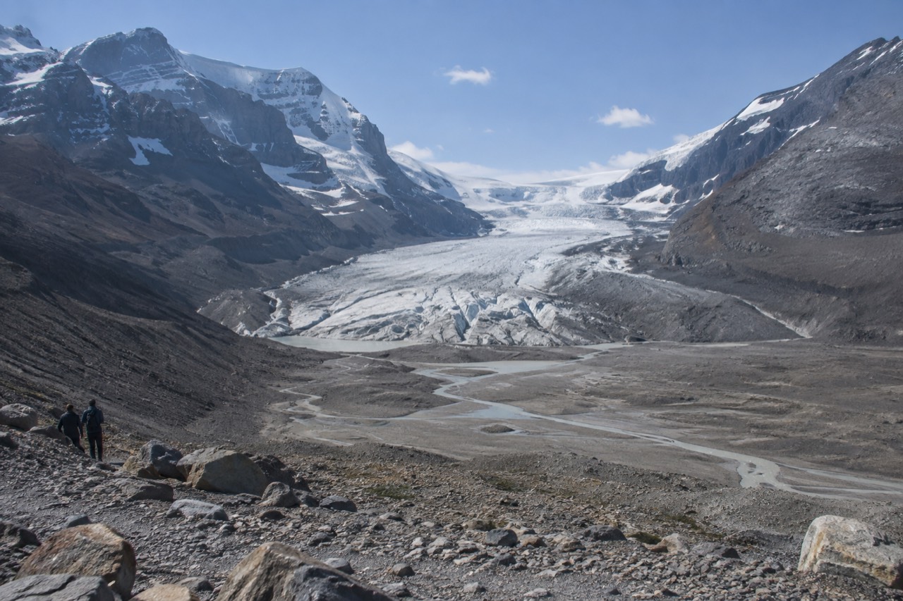 The Icefields Parkway winding between snow-capped peaks beside a glacial river