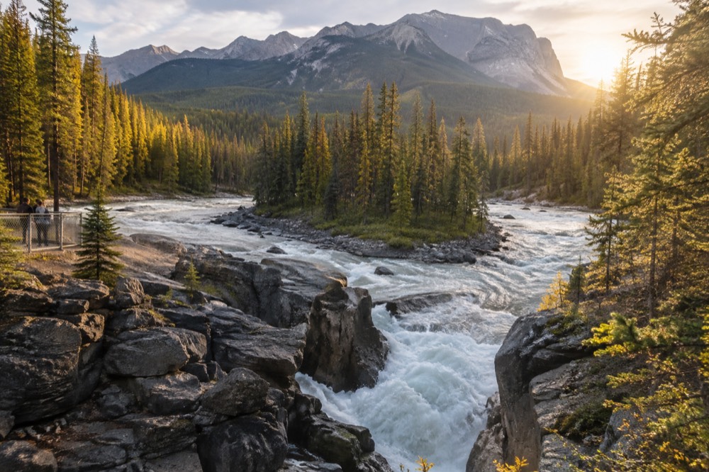 Golden autumn light on a mountain valley with a winding river below