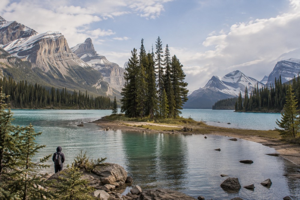 A long mountain lake with a small forested island near the far shore