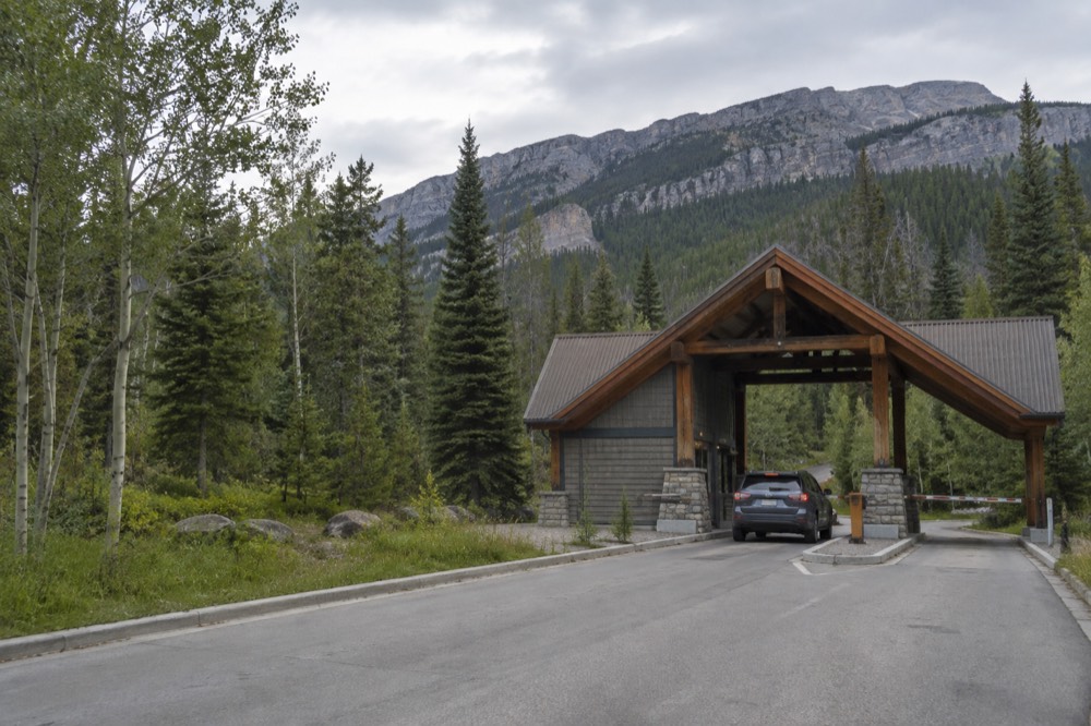A park entrance gate on a forested highway in the Canadian Rockies
