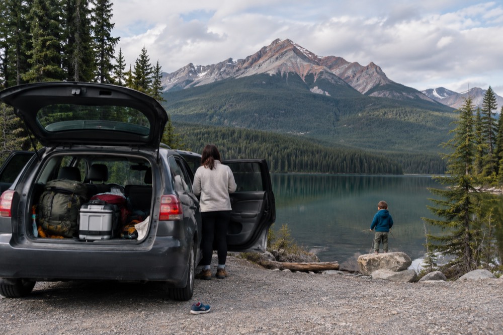 A family car parked at a mountain overlook in Jasper National Park