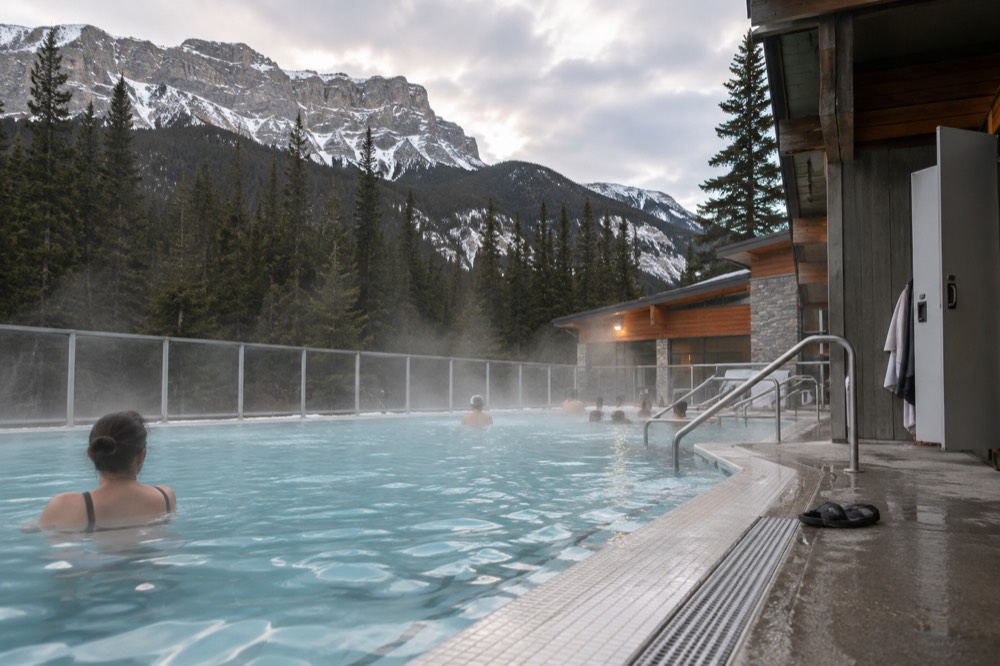 Warm water pools steaming beside a changing facility in a mountain valley