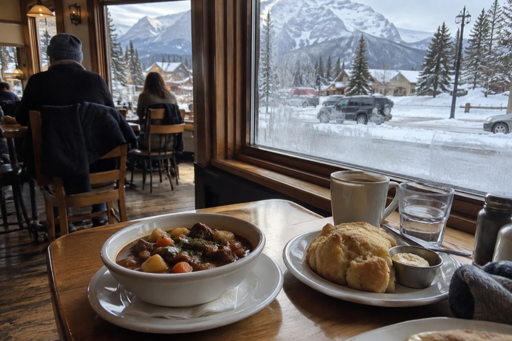 A small restaurant table with local dishes set for a food tour in a mountain town