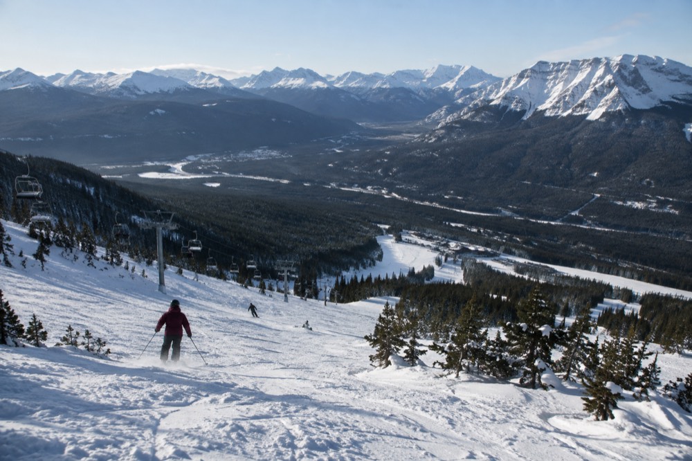 A snow-covered valley in Jasper National Park under a clear winter sky