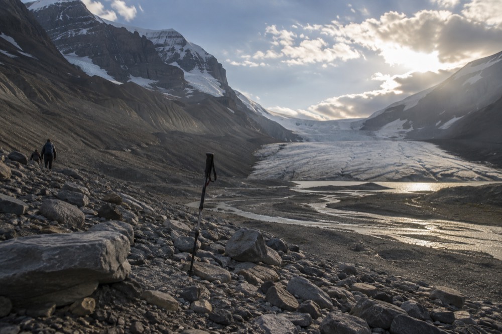 Athabasca Glacier toe with grey rocky moraine in the foreground and the icefield visible behind